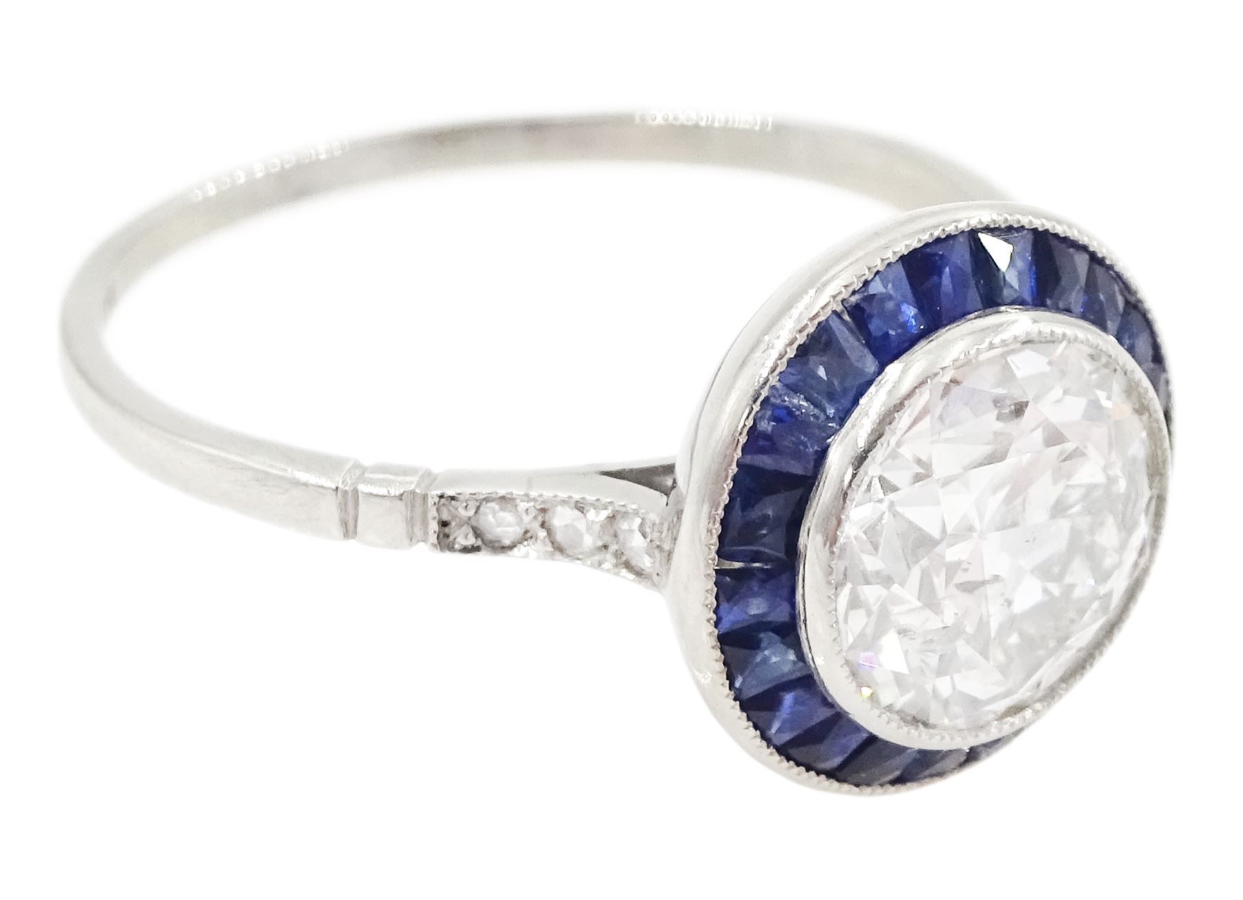 Platinum diamond and sapphire target ring, milgrain set single old cut diamond of 1.53 carat, with calibre cut sapphire surround and rose cut diamond set shoulders, stamped 950