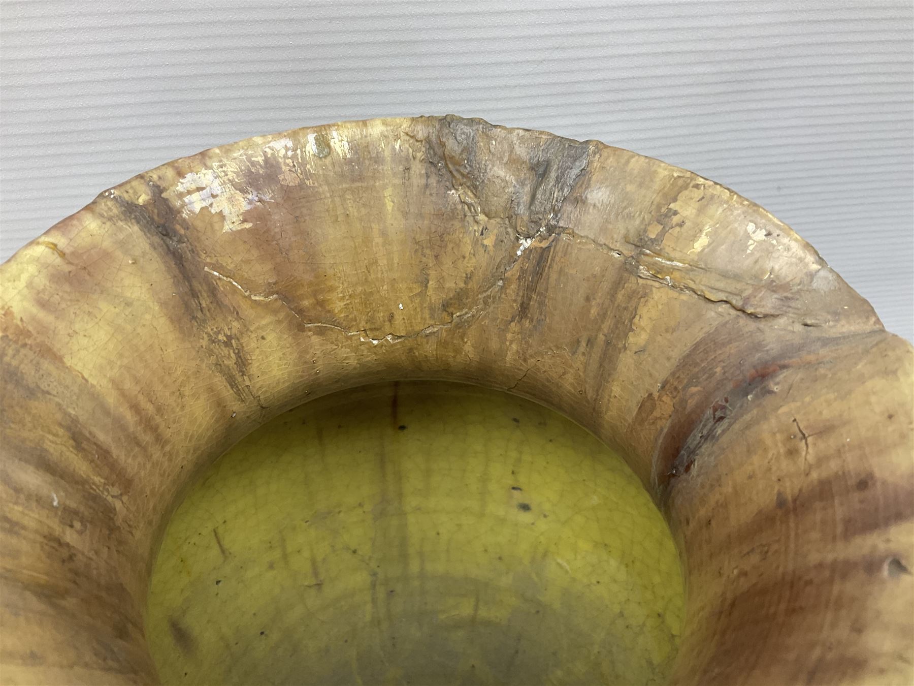 Early 20th century Royal Doulton stoneware vase, decorated with a stylized floral design below a wavy rim, monogrammed B.N, possibly for Bessie Newbery, H28cm, together with an early 20th century glazed jug, heavily carved throughout (2)