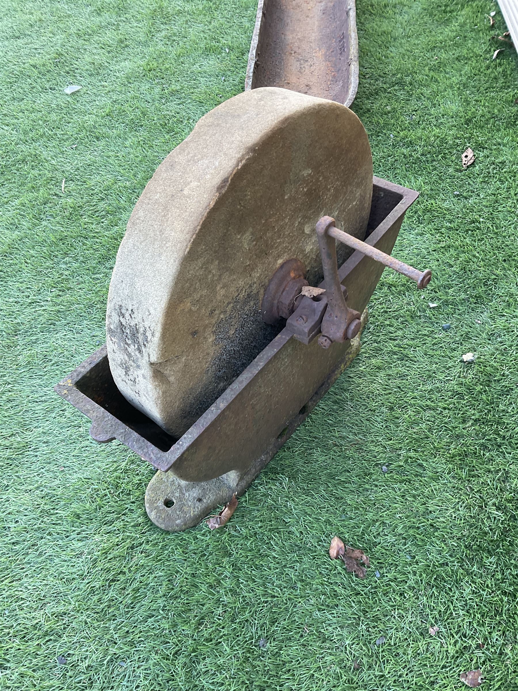 Small stone sharpening wheel, and a shallow cast iron trough - THIS LOT IS TO BE COLLECTED BY APPOINTMENT FROM DUGGLEBY STORAGE, GREAT HILL, EASTFIELD, SCARBOROUGH, YO11 3TX