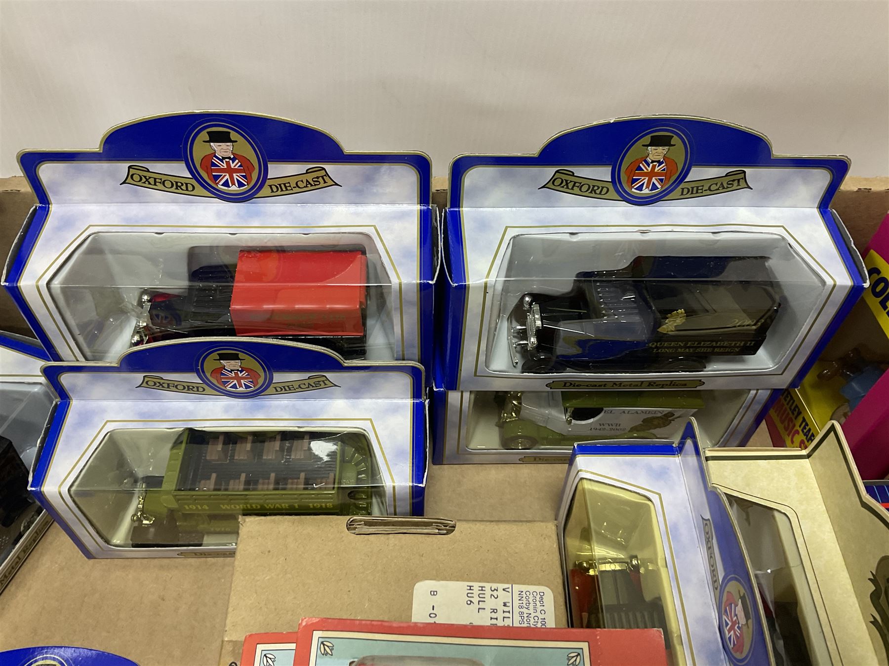 Collection of Tetley Tea collectibles to include sixteen 1:43 scale model cars from Lledo and Oxford Die-Cast with further Tetley Tea figures and tinned coaster set