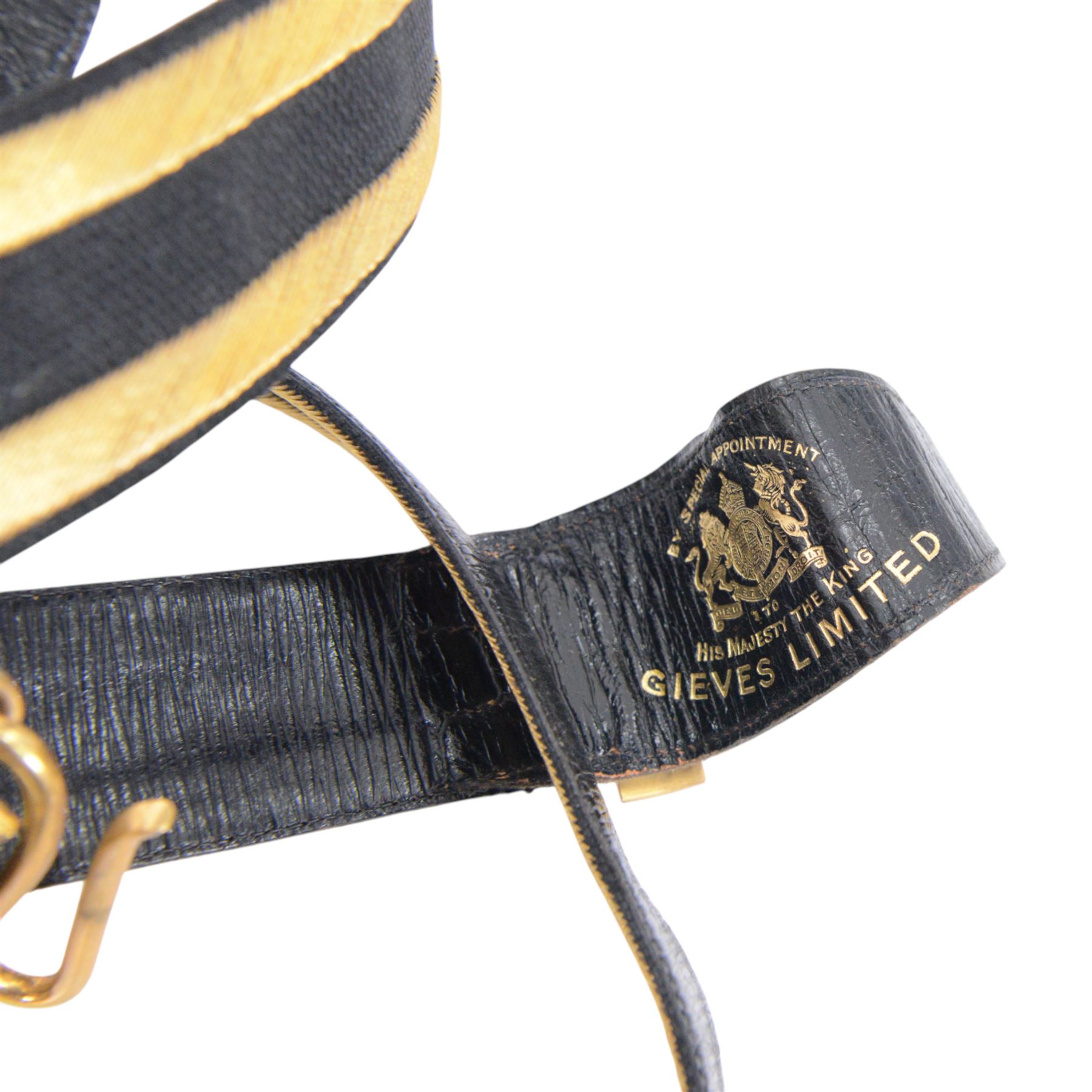 British 1827 pattern Naval officer's sword, named, by Wilkinson Sword Company in 1920 for P.H. Earle and retailed by Gives, the 80cm slightly curved blade etched to both sides, the brass guard held into scabbard by patent spring clip, lion head pommel and backstrap, with sword knot, within leather scabbard with three brass mounts, twin suspension rings and attached belt and suspension straps with gilt buckle and braid, overall L98cm 