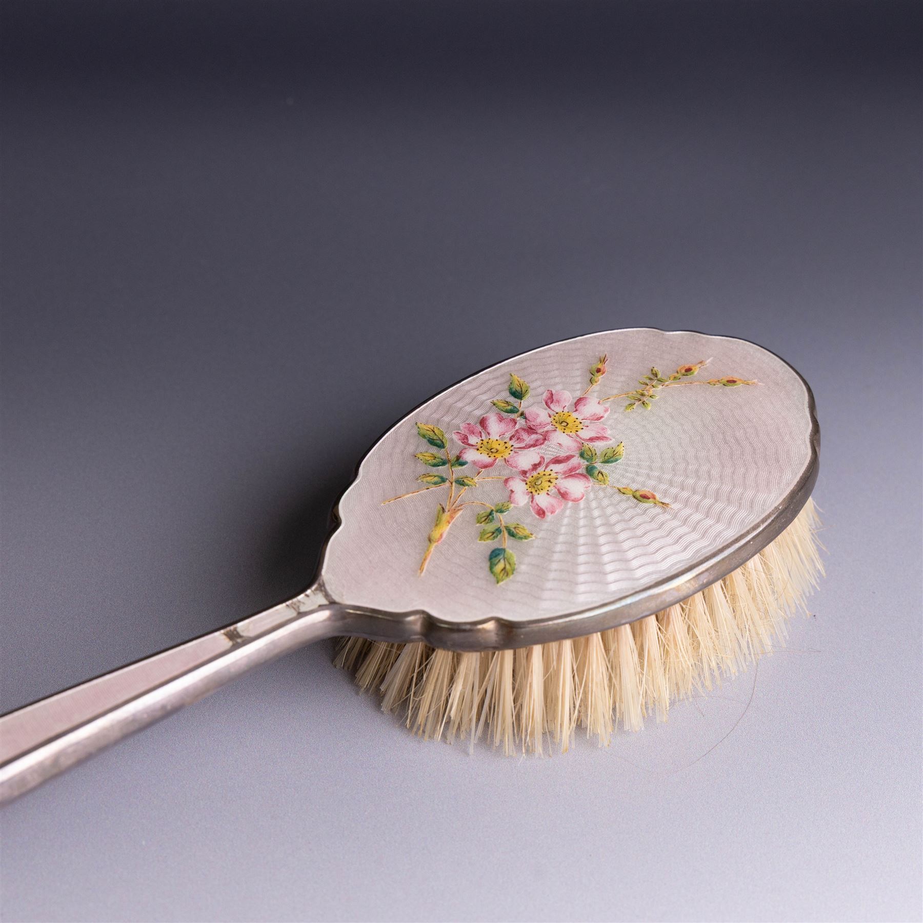 Mid 20th century silver mounted hairbrush and clothes brush, with guilloche enamel floral decoration, hallmarked Adie Brothers Ltd, Birmingham 1960, together with an silver mounted glass scent bottle, the glass with etched floral decoration and engine turned cover, hallmarked 