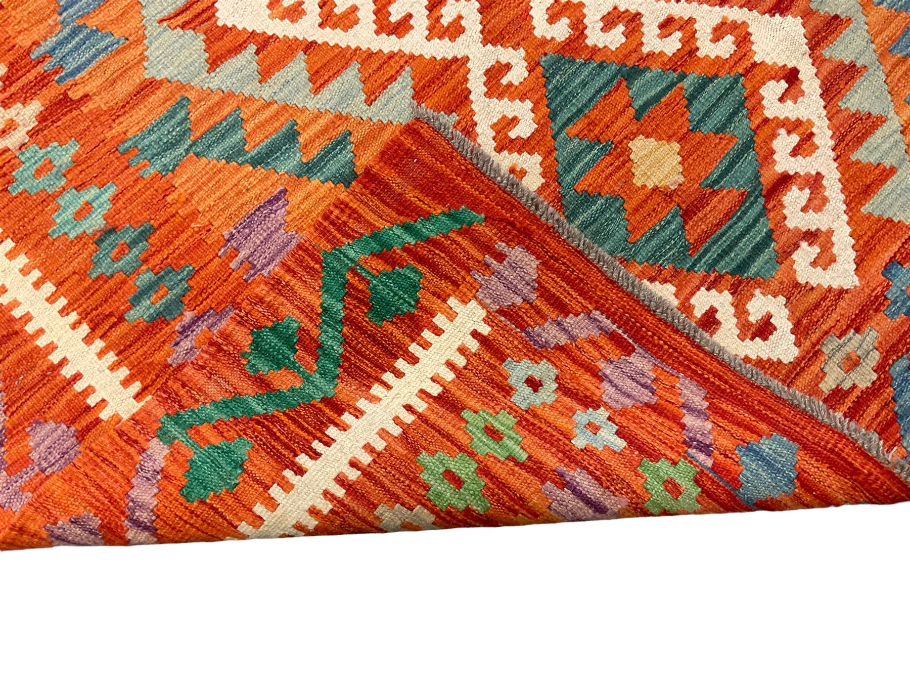 Anatolian Turkish Kilim amber ground rug, the field decorated with four lozenges with ivory outline, the double banded orange border with repeating geometric patterns 