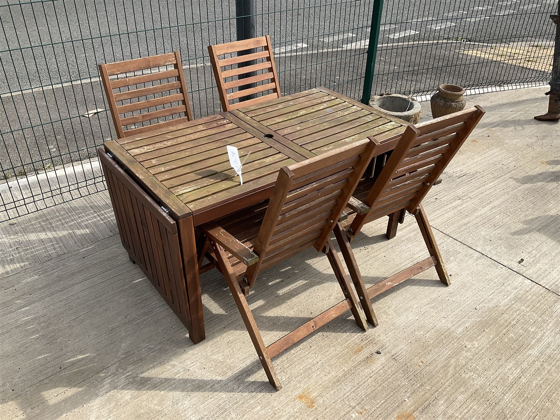 Rectangular teak drop leaf garden table, and four slatted armchairs