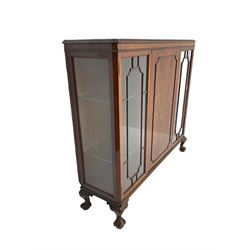 Late 20th century mahogany display cabinet, moulded and foliate carved rectangular top, enclosed by central figured door flanked by two glazed doors, scroll and acanthus carved ball and claw feet