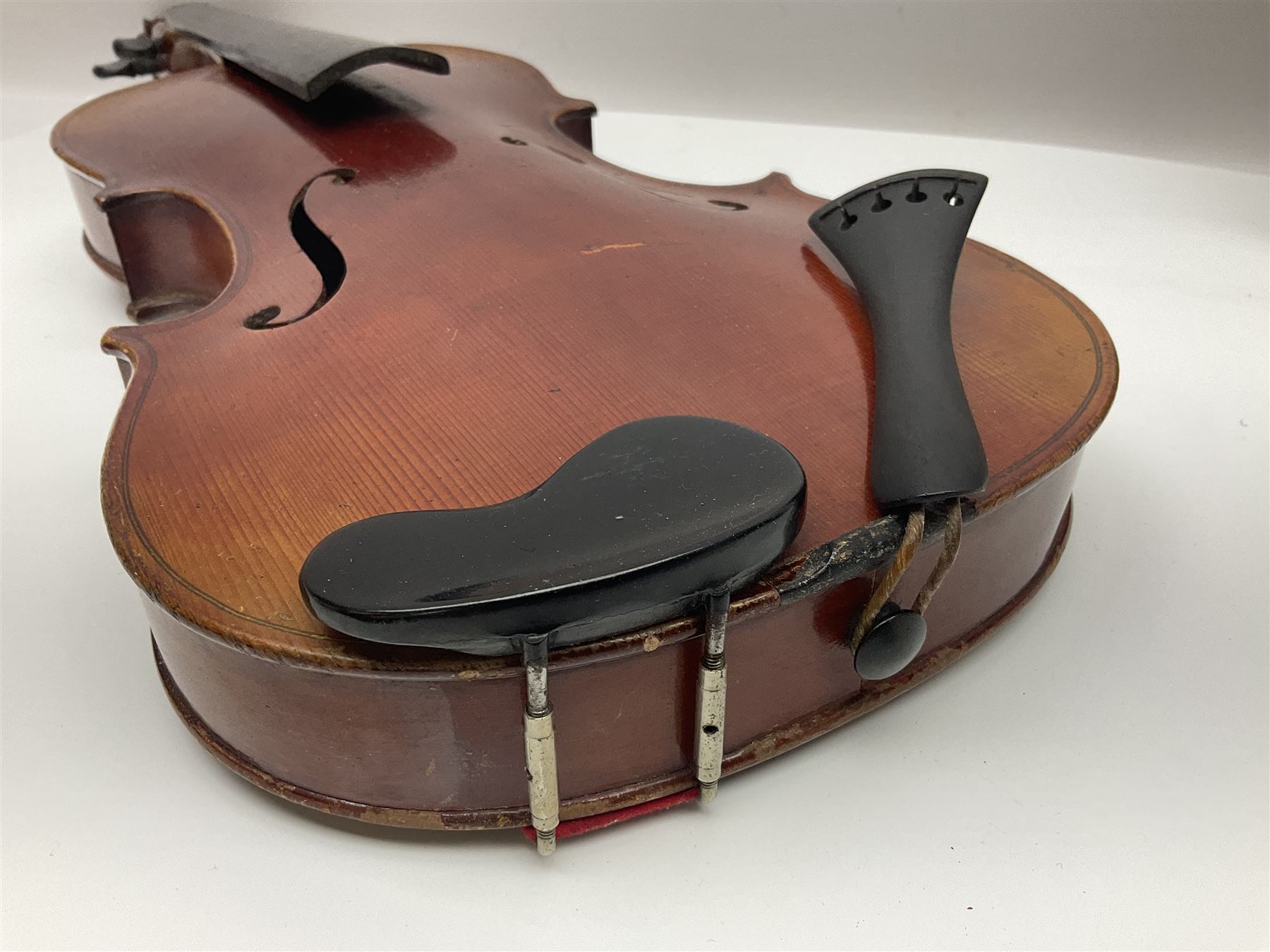 Late 19th century French three-quarter size 'Conservatory' violin with 34cm two-piece maple back and ribs and spruce top, the peg box inscribed 'Conservatory Violin Straduari', bears label 'Antonius Stradiuarius Cremonensis Faciebat Anno 1721' L55.5cm overall; in ebonised wooden 'coffin' case; and Saxony violin c1900 with 36cm two-piece maple back and ribs and spruce top; bears label 'Antonius Stradivarius Cremonensis Faciebat Anno 17**' L59cm overall; in carrying case (2)