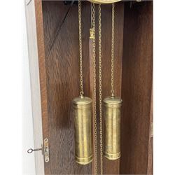 Early 20th century Art Deco oak longcase clock, circular dial with roman numerals and minute track, dial signed 'Barnby & Rust, Hull', twin chain driven movement striking the hours on gong rods. With weights and Pendulum.