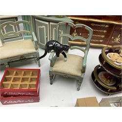 Collection of miniature dolls house furniture, to include display cabinet with pink and white floral dinner service, two serving trolleys with cakes and sweets and two blue painted kitchen dressers, together with miniature dolls house cardboard food packaging and animal figures including dogs and cats, etc