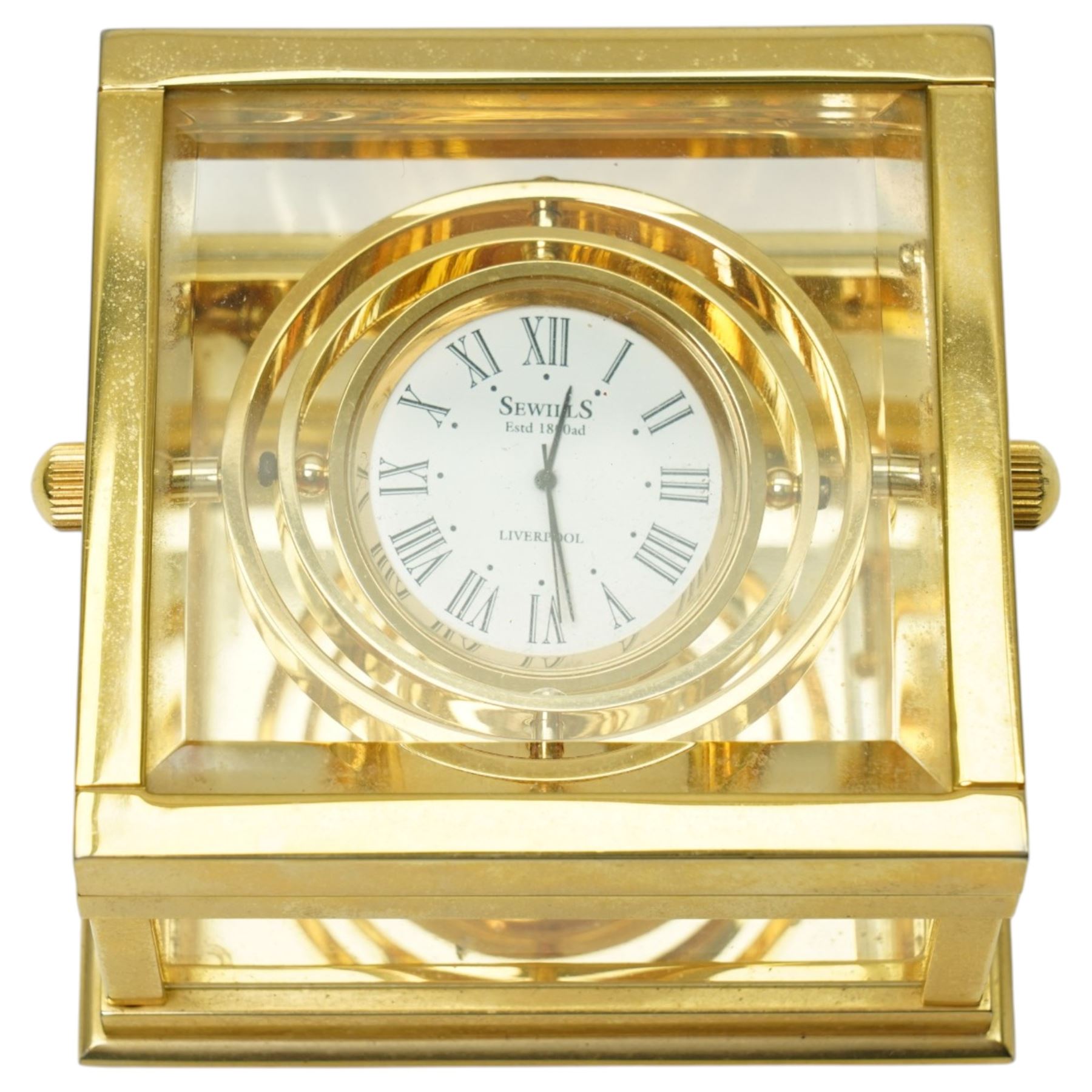 Sewills of Liverpool gilt gimbal mounted desk clock with white dial in brass and bevelled glass square case 8cm