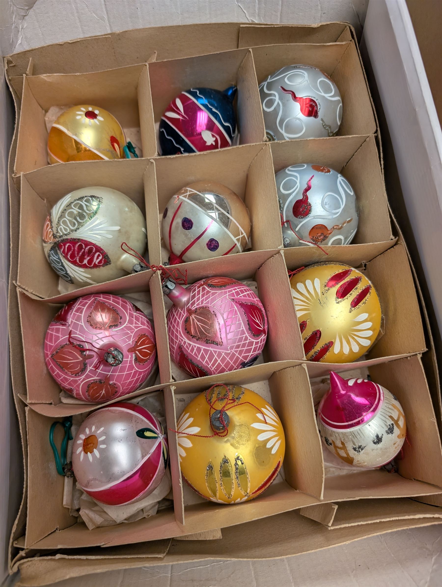Collection of colourful vintage Christmas decorations, including glass and metal baubles