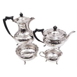 1920s silver four piece tea service, comprising teapot, hot water pot, milk jug and open sucrier, each with shaped rim and upon three pad feet, the hot water pot and teapot each with ebonised wooden finial and handle, teapot, sucrier and jug hallmarked James Ramsay, Sheffield 1923, hot water pot hallmarked Atkin Brothers, Sheffield 1921, all housed within canvas drawstring bags for the retailer J Ramsay, Dundee