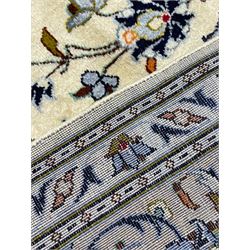 Persian Kashan ivory ground carpet, decorated all-over with interlacing foliate and stylised plant motifs, central scrolling medallion and matching spandrels, the guarded border decorated with repeating palmettes
