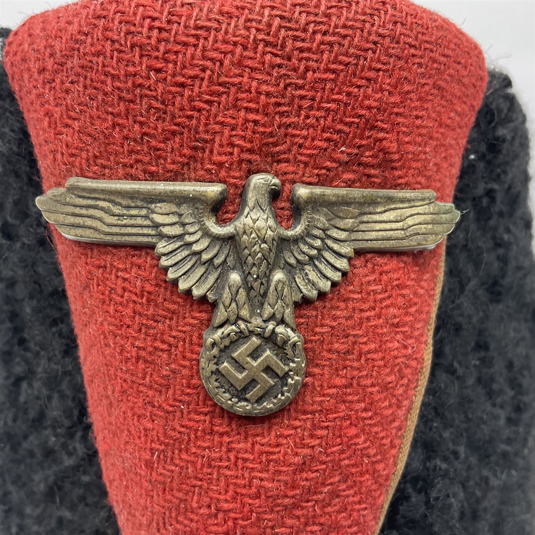 WW2 German small size Balkan style hat with 'SS' metal badges; red cloth top and flash to front with black persianelle type sides; lined in brown card with leather sweatband