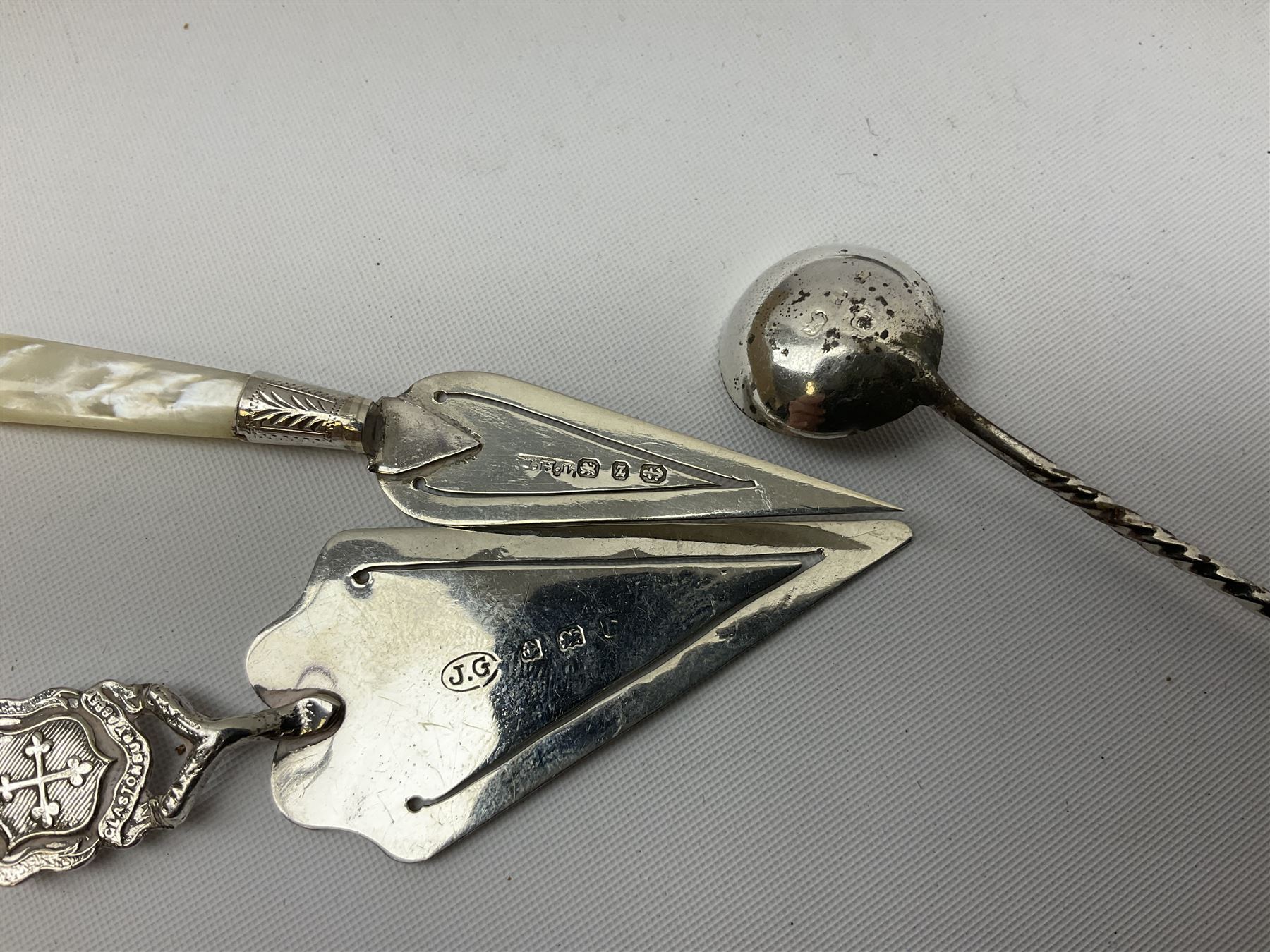 Two small silver page markers in the form of trowels, both hallmarked, together with a small silver and enamel dish, decorated with central panel of flowers, with London import mark, and a small group of flatware, to include Victorian salt spoon, approximate gross weight 111.6 grams