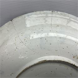 Early 18th century Delft marriage plate, of circular form with dished centre, the centre inscribed and dated 'Thomas and Elizabeth Kockerill Bridlington Key 1715' within a crowned C scroll cartouche, flanked by demi-griffins, above a putto head and tassels, within a wide foliate border, D34cm
