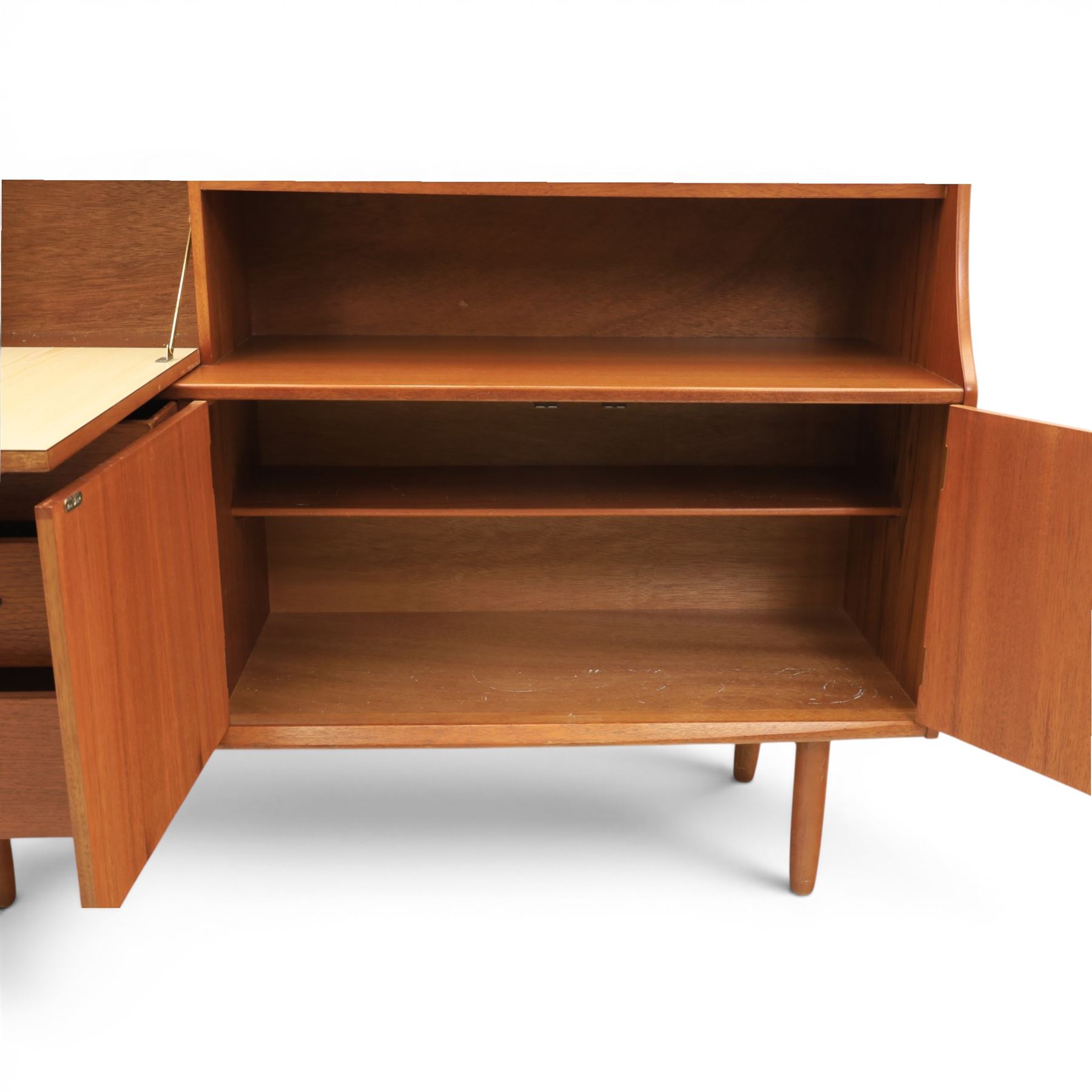 Jentique - mid-20th century teak highboard, fall front cabinet next to a sliding door cupboard above and open recess, the lower section with cabinet doors and three graduated drawers, raised on cylindrical legs
