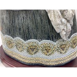 Large Lladro figure, La Menina, modelled as a maid of honor in service, on a mahogany oval base, limited edition 99/1000, sculpted by Jose Puche, with certificate of authenticity, framed and glazed, no 1812, year issued 1996, year retired 2019, H60cm