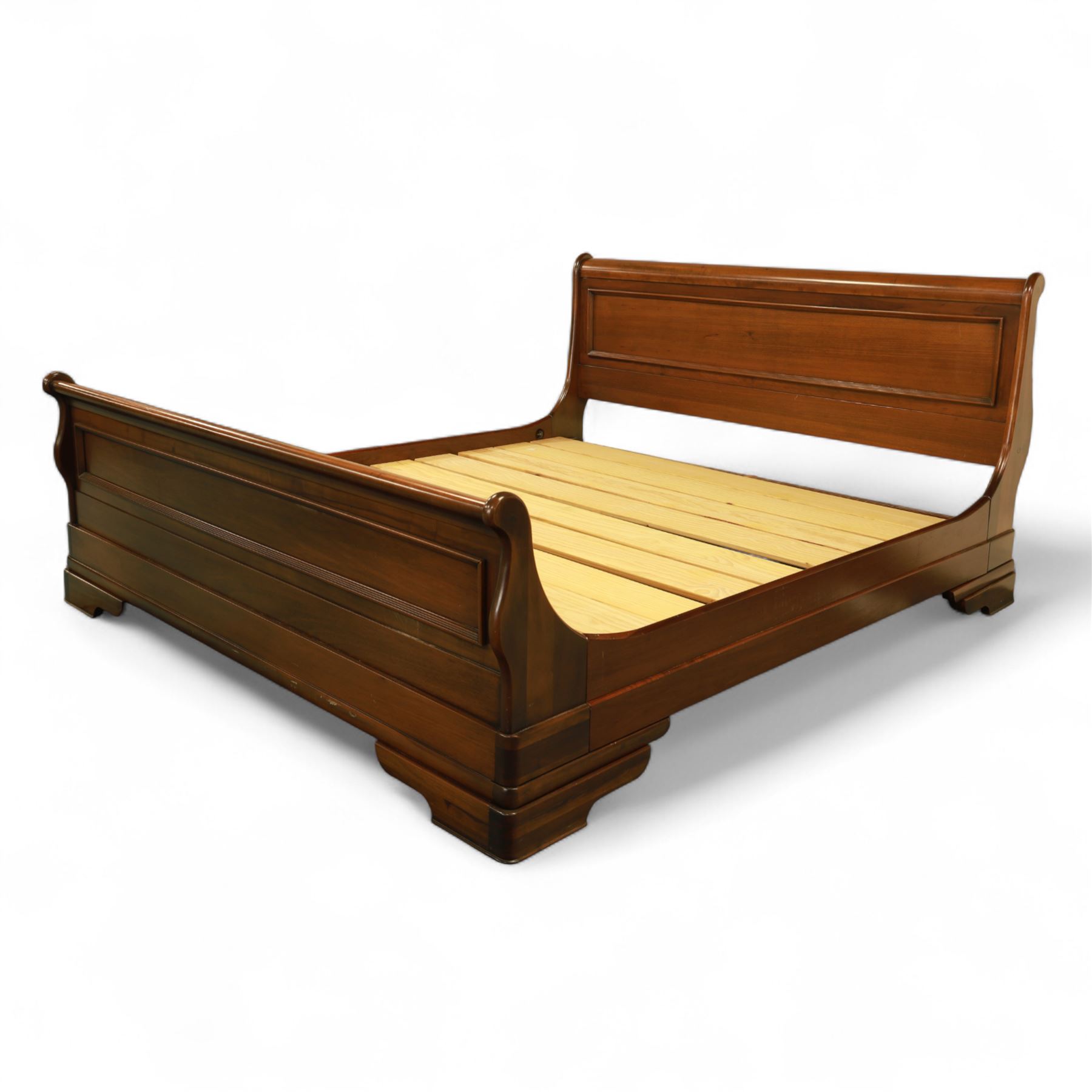 Willis & Gambier - 20th century mahogany sleigh bed, panelled headboard and footboard with scroll terminals, raised on moulded plinth base