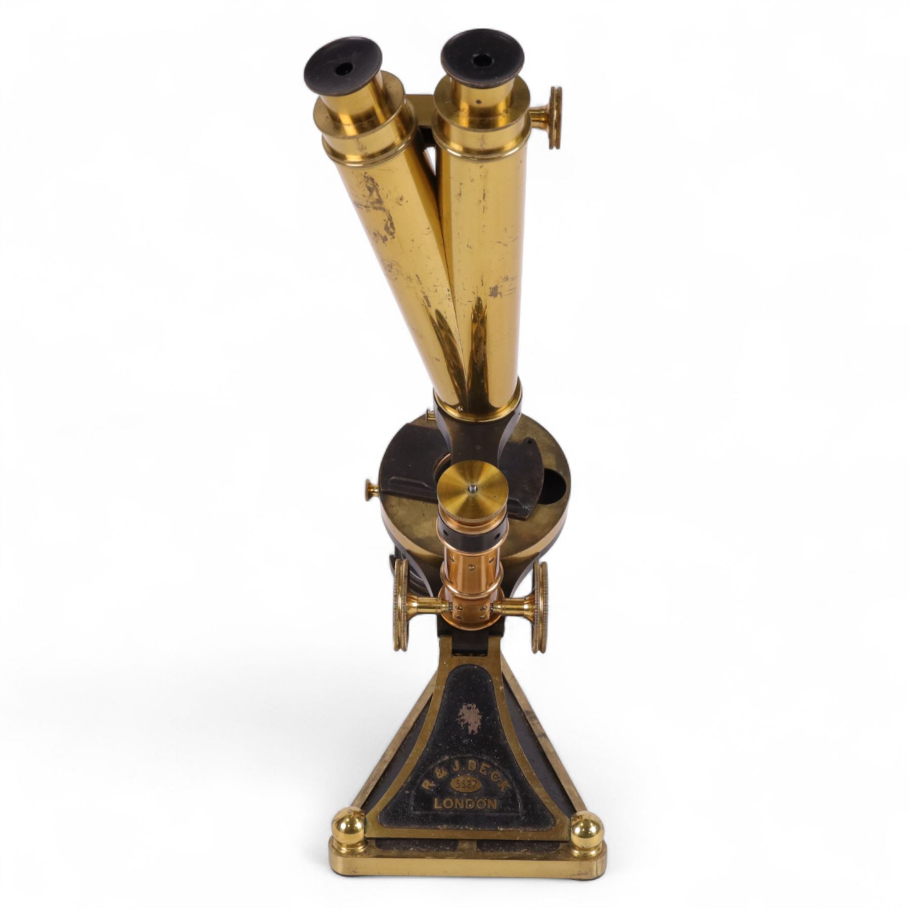 19th century brass binocular microscope by R&J Beck, London, numbered 5527, with rack and pinion focusing, with four eye pieces and three objective lenses, in wooden case