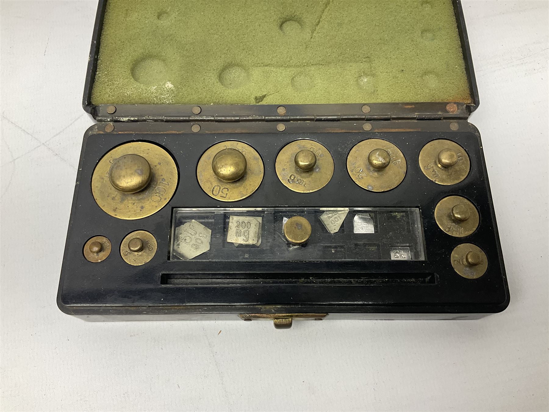 Set of laboratory balance scales by Reynolds & Branson of Leeds in fully glazed mahogany case with rise-and-fall front door, black vitrolite base with brass feet and hand cranked action L40cm H51.5cm D30cm; and bakelite cased set of brass weights