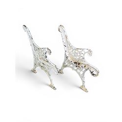 Pair of ornate painted cast iron bench ends, painted in white finish