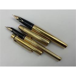 Sheaffer Triumph Imperial fountain pen, the gold plated barrel with fluted stripe design and gold nib stamped 14K 585, together with a Sheaffer Targa slimline fountain pen with gold plated barrel similarly decorated with gold nib stamped 14K 585, ballpoint pen and propelling pencil, each with a fluted gold plated barrel, largest L13.5cm (4)