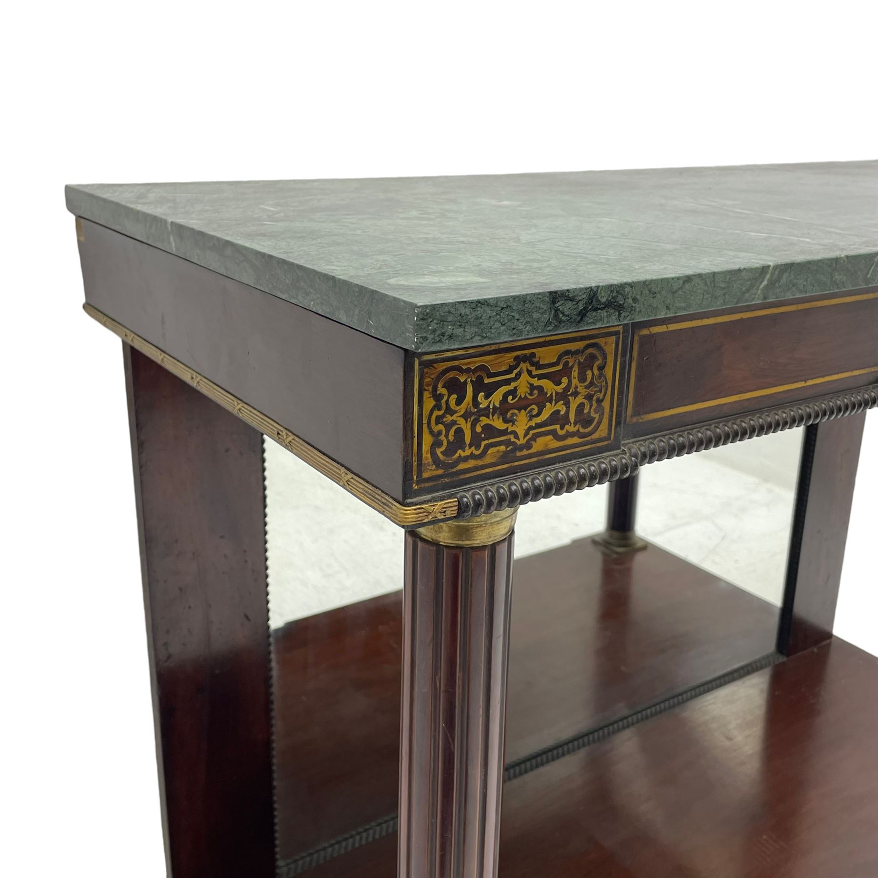 Late 19th century mahogany console or pier table, rectangular green marble top over a break-front frieze inlaid with brass scroll work panels, reed and ribbon gilt metal and wooden beaded applied mouldings, on turned and fluted front supports, plain mirror back over plinth platform base