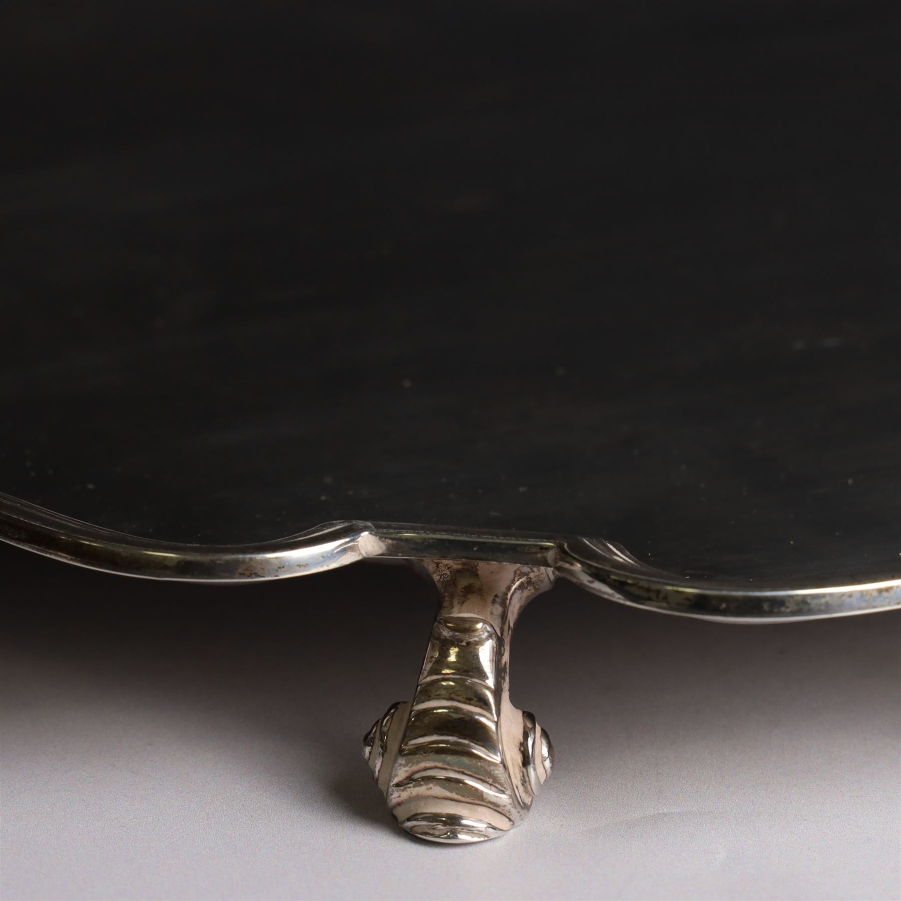 Mid 20th century silver tray, with shaped rim and upon three scroll feet, William Suckling Ltd, Birmingham 1946, D36cm
