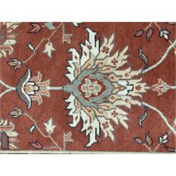Late 20th century Royal Keshan 'Agra' hand-knotted wool rug, terracotta ground with central floral medallion and scrolling vines, enclosed by a cream border with repeating floral motifs