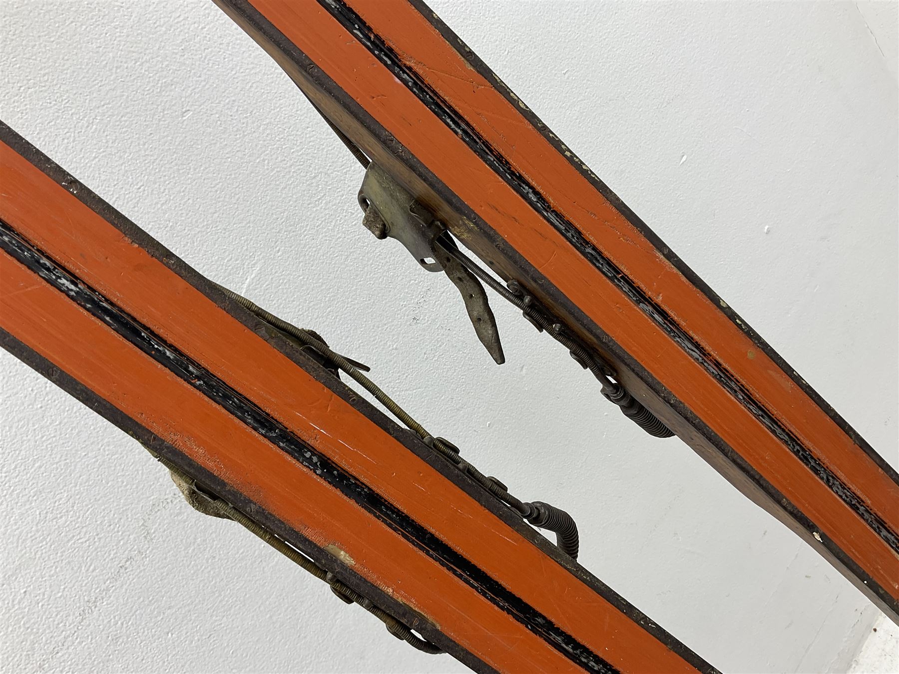 Pair of 1930s wooden skis, with painted metal runners beneath stamped Attenhofer, with retailers label for Ernst Gertsch Central Sports, L206cm