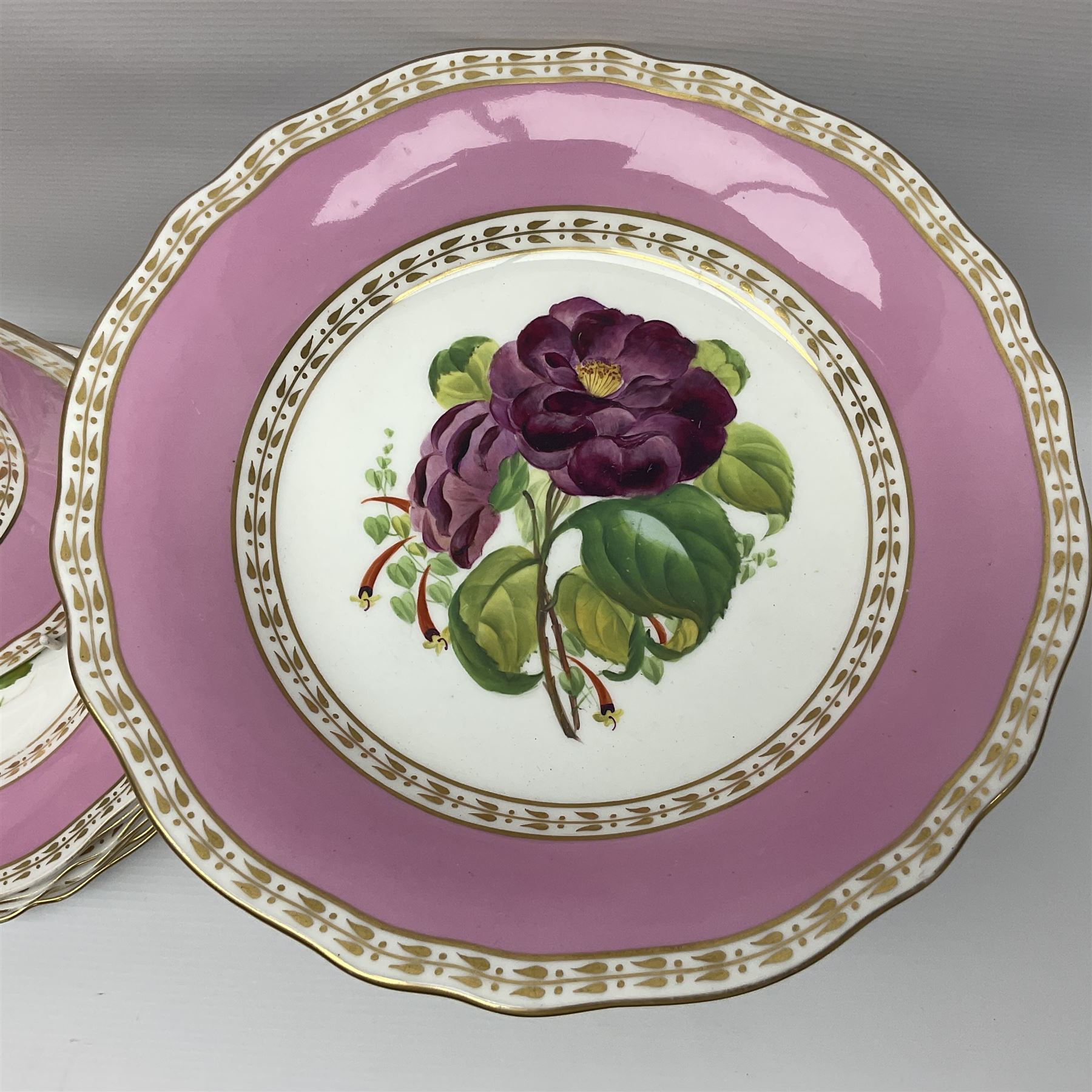 Victorian Copeland, Botanical dessert service, decorated with floral sprigs to the centre with a pink and gilt border, comprising five comports and seven plates, largest comport H20cm, plate D22cm