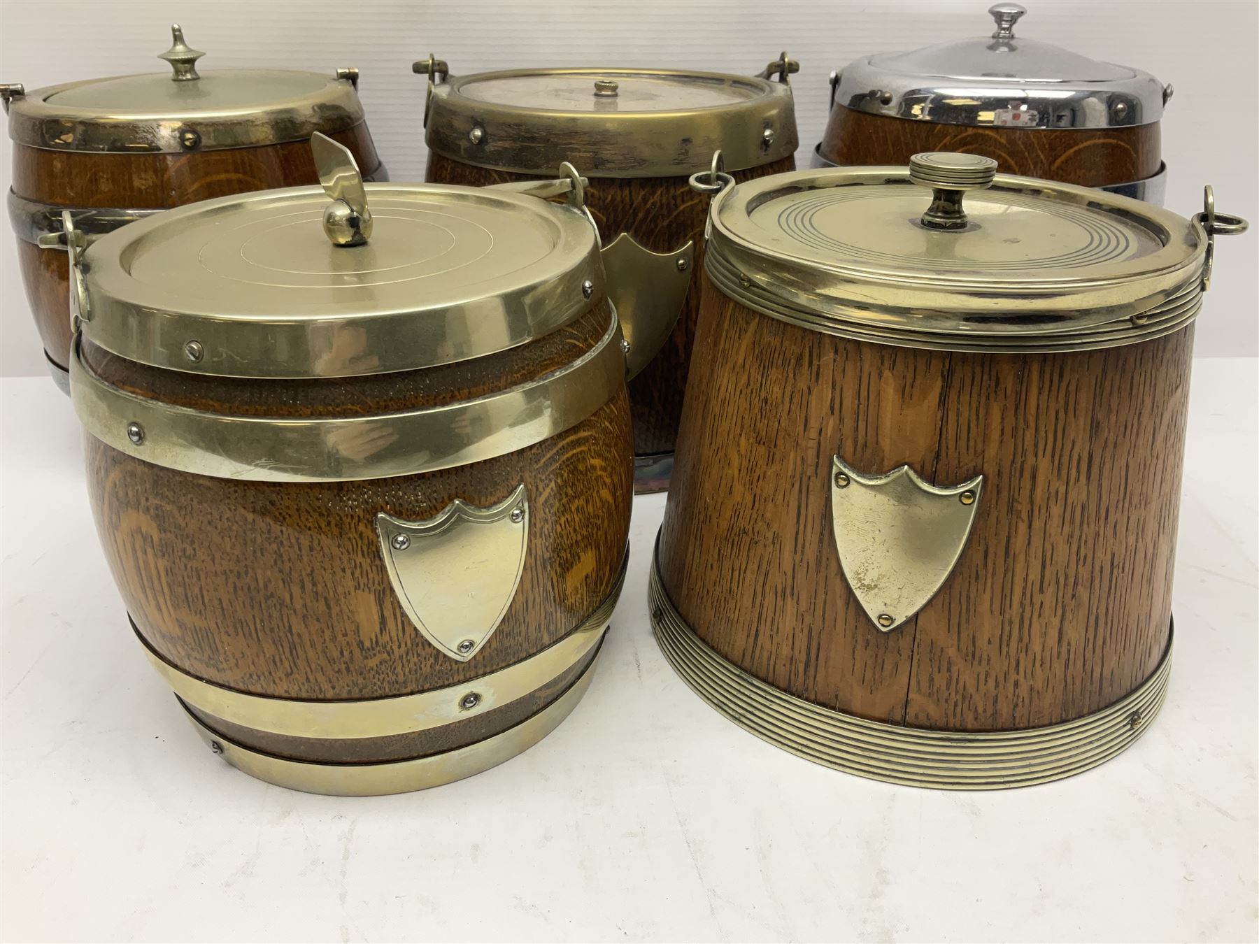 Five early 20th century biscuit barrels with silver-plated mounts