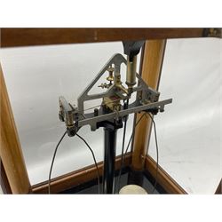 Set of laboratory balance scales by Reynolds & Branson of Leeds in fully glazed mahogany case with rise-and-fall front door, black vitrolite base with brass feet and hand cranked action L40cm H51.5cm D30cm; and bakelite cased set of brass weights