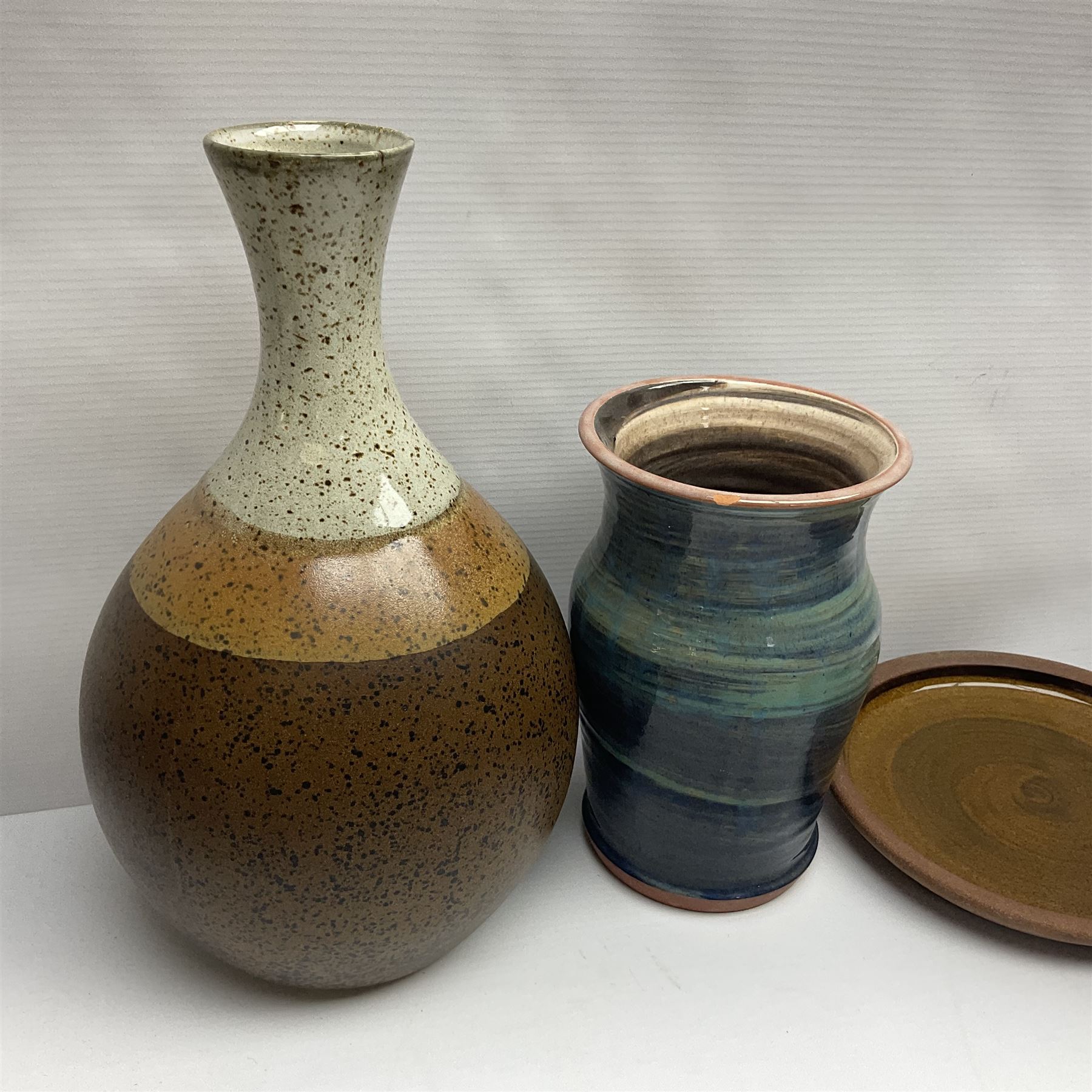 Wold studio pottery tankards, in various colours and relief decoration together with other studio items including vases, jugs and pots 