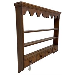 Polished pine three-tier wall hanging plate rack, moulded cornice over shaped frieze rail, fitted with four drawers 