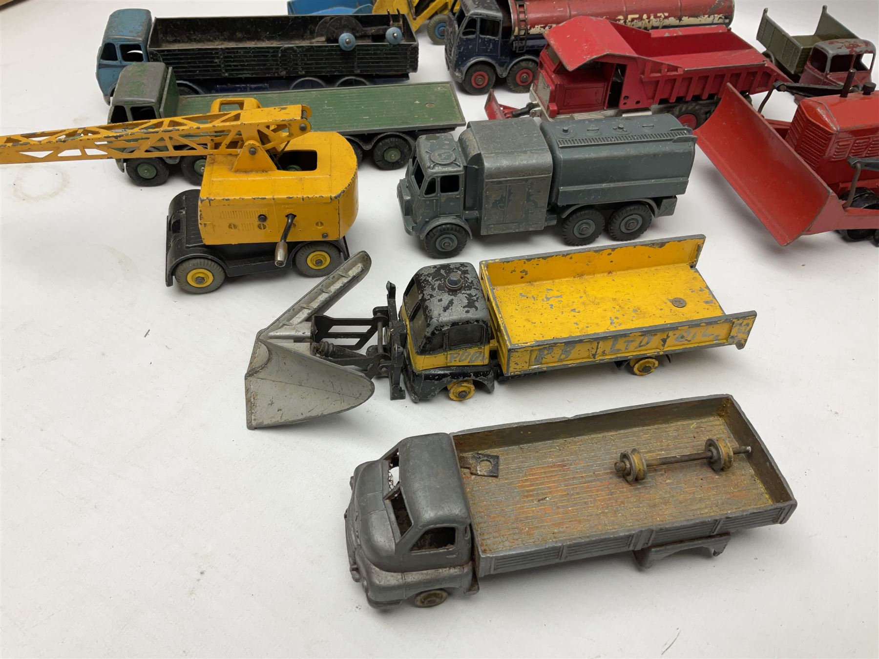 Dinky - twenty-six unboxed and playworn die-cast models including Foden Regent Tanker, two Foden lorries, Pressure Refueller No.642, Snow Plough, Elevator Loader, Foden Dump Truck, Blaw Knox Bulldozer and other commercial vehicles