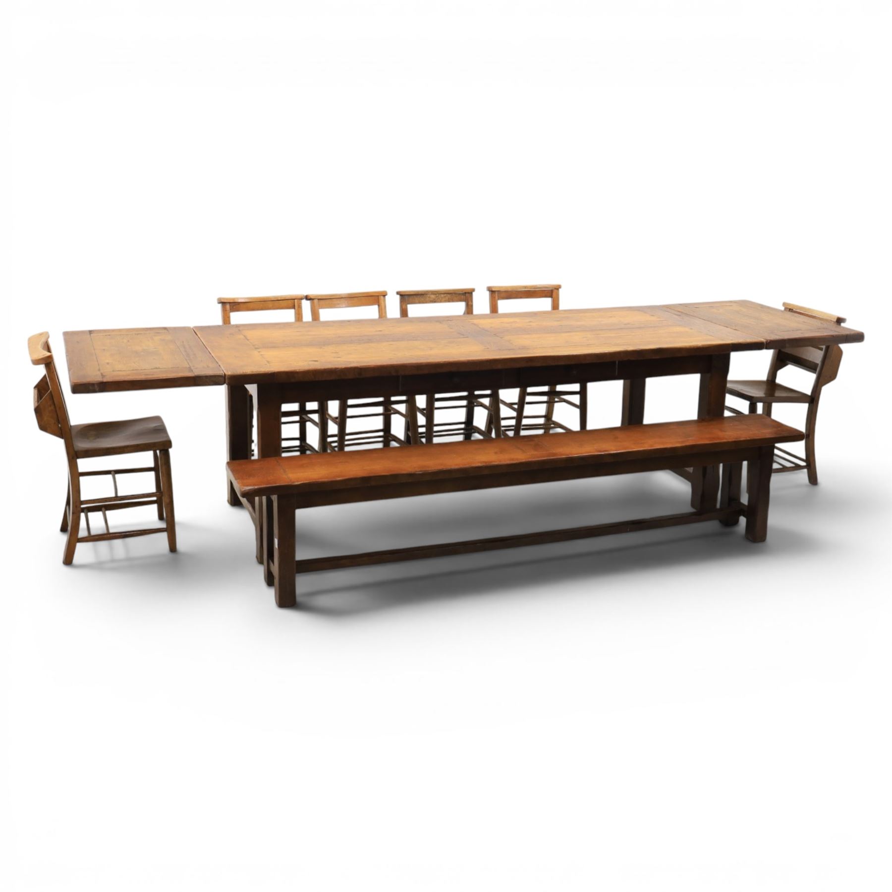 Country pine draw leaf table, bench seat and six chapel chairs, the top of plank construction, with two frieze drawers, additional leaves extending to 320cm, with bench seat and six elm chapel seats