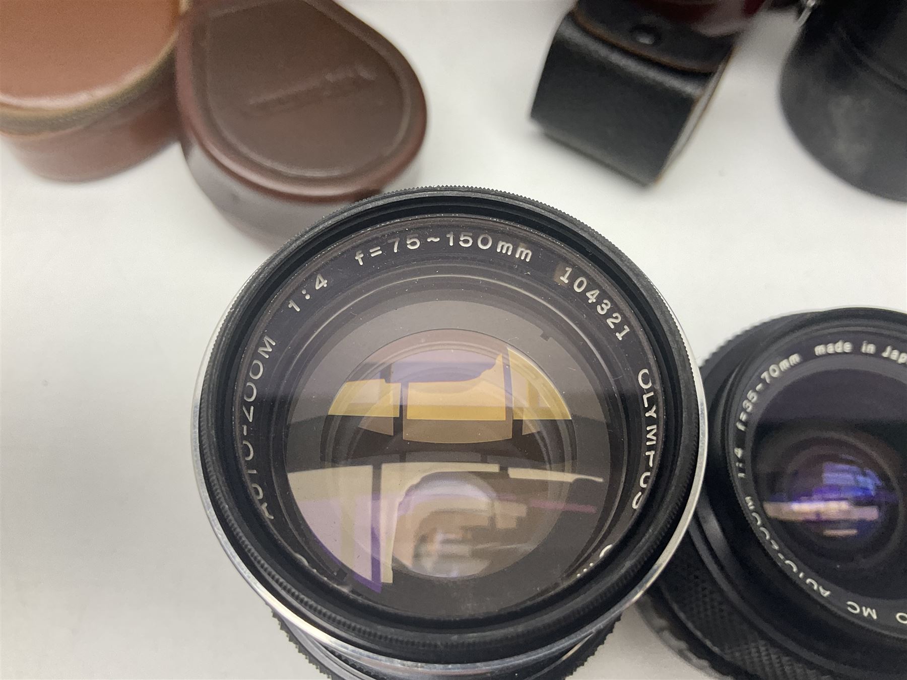 Collection of camera bodies and lenses, to include Olympus OM-1 camera body, serial no 106567, with 'Olympus OM-System F.Zuiko Auto-S 1:1.8 f=50mm' lens, serial no 135097,  Zenit-B camera body, serial no 71017867, with 'Helios-44-2 2/58' serial no 7500040, Voigtlander Vito B camera body, with 'Voigtlander Colour Skopar 1:2.8/50' lens, 'Olympus OM-System Zuiko Auto-Zoom 1:4 f=75-150mm' lens serial no 104321, 'Tamron SP 35-210mm 1:3.5-4.2' lens etc 
