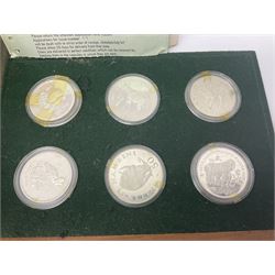 The Royal Mint 'Conservation Coin Collection' formed of twenty-four silver proof coins, housed in the wooden display case, with information booklet