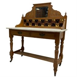 Late Victorian satin walnut washstand, raised bevelled mirror and tiled back carved with scrolled foliage, white marble rectangular top over two drawers, on collar turned supports joined by under-tier 