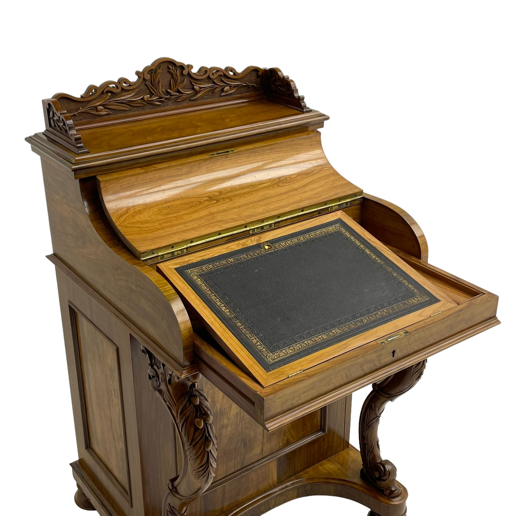 Fine and unusual 19th century olivewood piano top davenport, raised shaped back carved with olive branches and olives, the top hinges to reveal lidded and correspondence compartments, the piano lid enclosing sliding top with hinged and adjustable writing surface with leather inset, right-hand panelled door enclosing four drawers, olive branch and scroll carved cabriole front supports on moulded and shaped platform, turned cup feet with recessed castors 