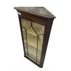 Early 20th century Georgian design mahogany wall-mounted corner display cabinet, projecting cornice with dentil frieze over astragal glazed door enclosing three fabric-lined shelves