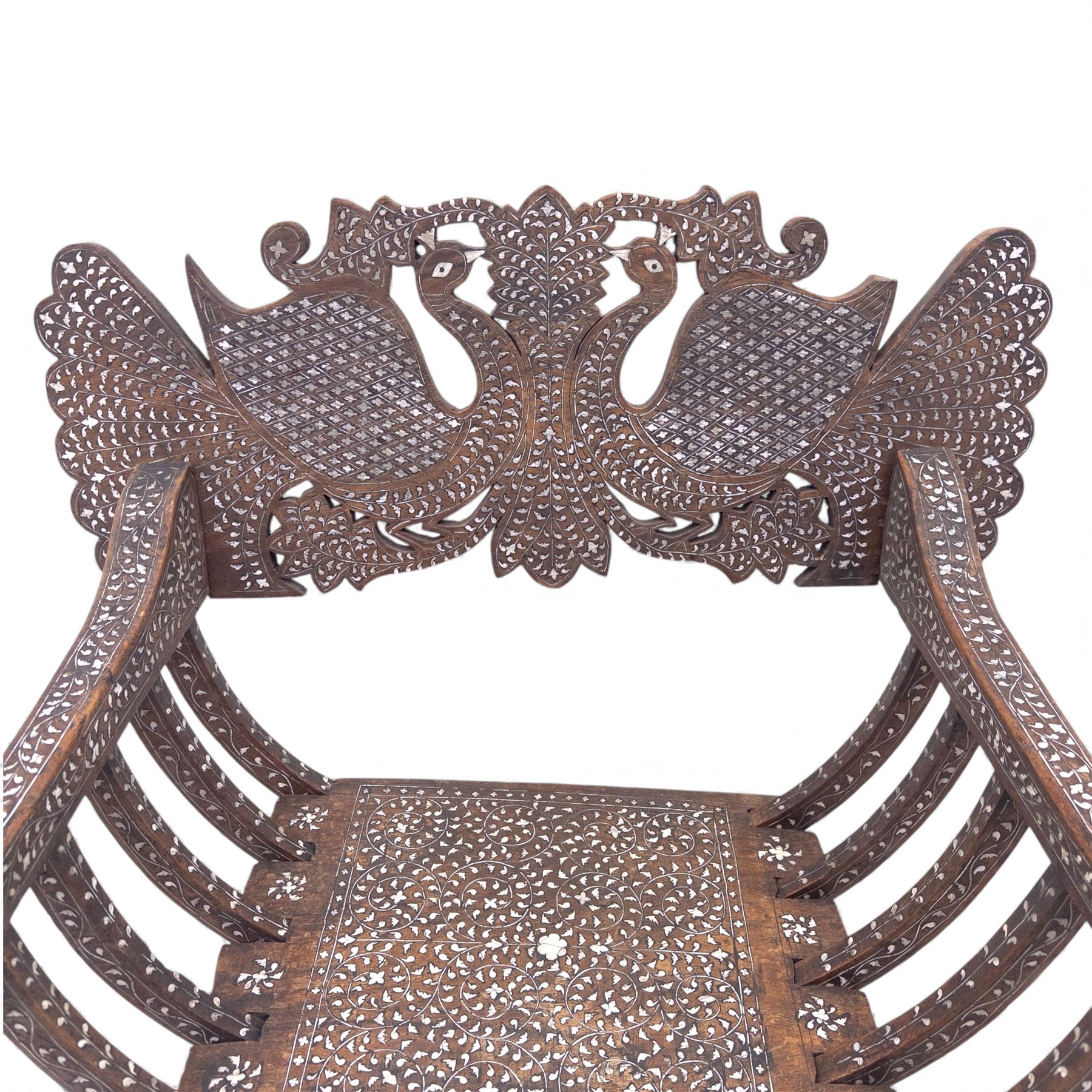 Anglo-Indian bone inlaid hardwood Savonarola chair, the pierced back finely carved with opposing peacocks amongst scrolling foliage, the seat, arms, and X-frame supports. This item has been registered for sale under section 10 of the APHA Ivory Act Reference QWLLGKZM