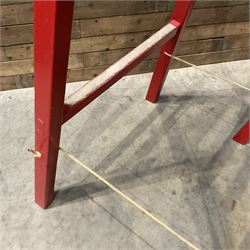 Pair of vintage red painted A frame trestles, with original A W Oates Painter signage