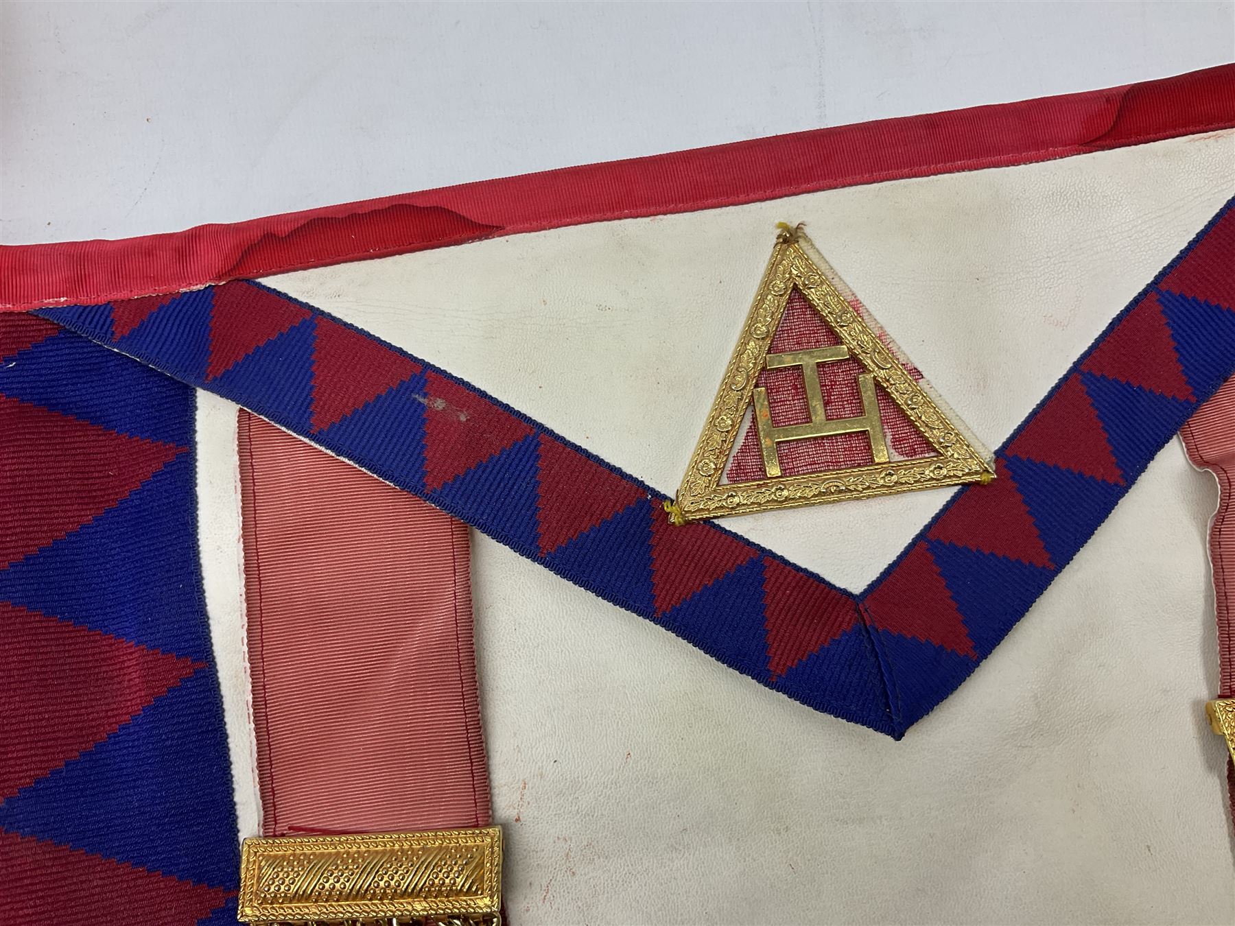 Two Masonic kid leather aprons, one with sash and cuffs, the other with sash, each marked 'Yorkshire North and East Ridings'; and three other unmarked Masonic aprons with sashes