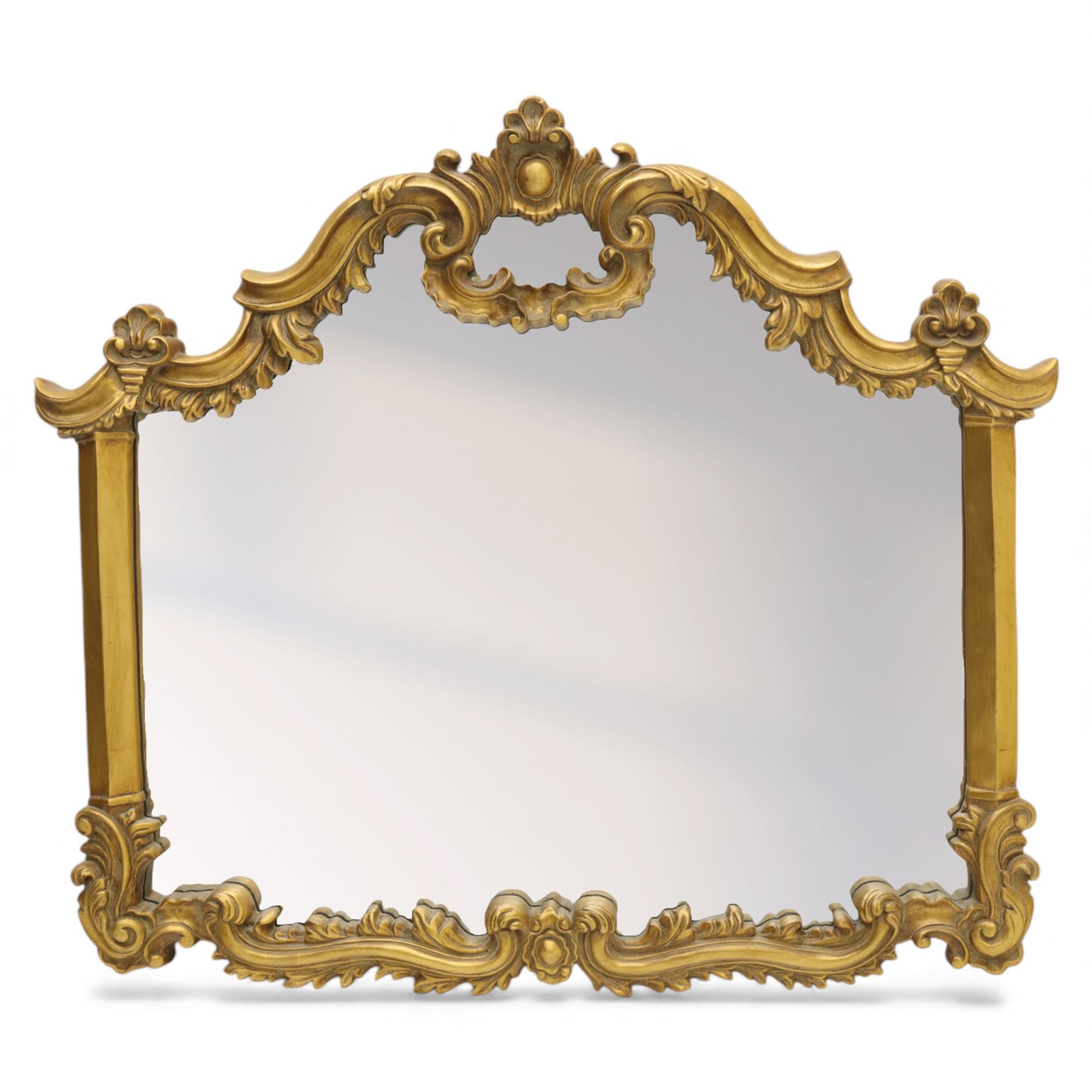 Late 20th century giltwood and composition over mantel mirror, with shaped and scrolled cresting centred by a shell cartouche, with foliate moulded shoulders and lower rail framing a rectangular plate