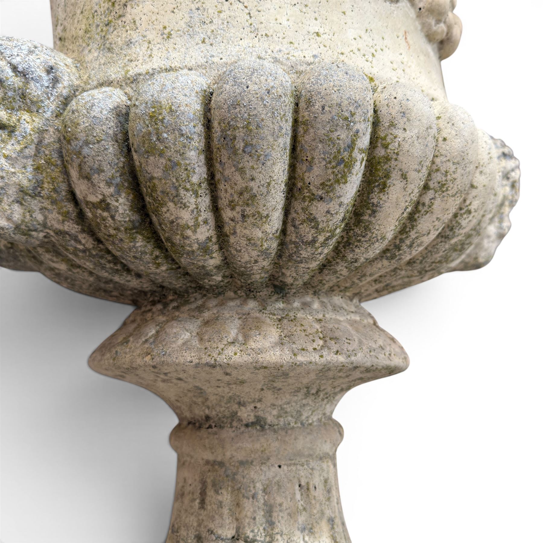 Pair of large cast stone garden urns, circular form with egg and dart border, tapering gadrooned bowl with cast handles and detail
