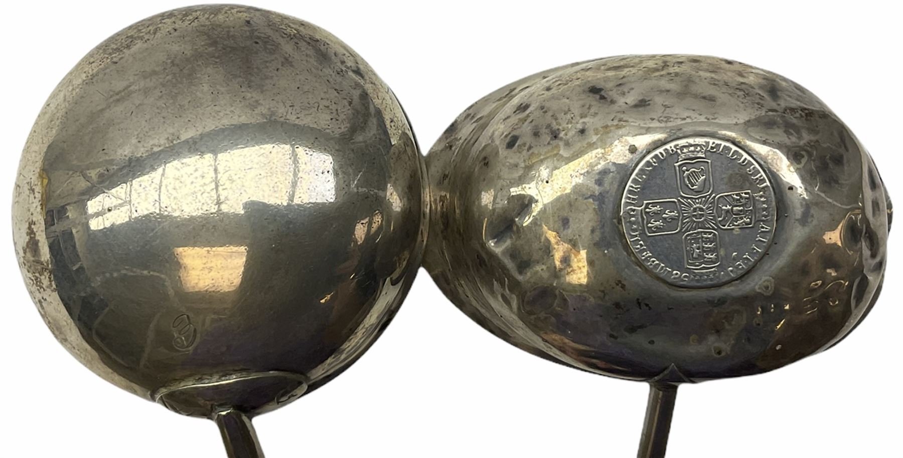Two Georgian silver toddy ladles with baleen twist handles, (neither hallmarked), one with inset coin to bowl, together with a group of silver plate including cruet stand enclosing two glass bottles with stoppers, shaker and preserve pot with spoon, pair open salts with glass liners, etc. 
