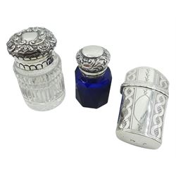 Georgian silver needle case, of tapering form with bright cut decoration, hallmarks worn and indistinct, marked SP probably for Samuel Pemberton, together with two Victorian scent bottles, the first example with facet cut blue glass body and hinged foliate embossed cover opening to reveal a stopper, hallmarked C C May & Sons, Birmingham 1897, the second hallmarked John Grinsell & Sons, London 1893, (3)