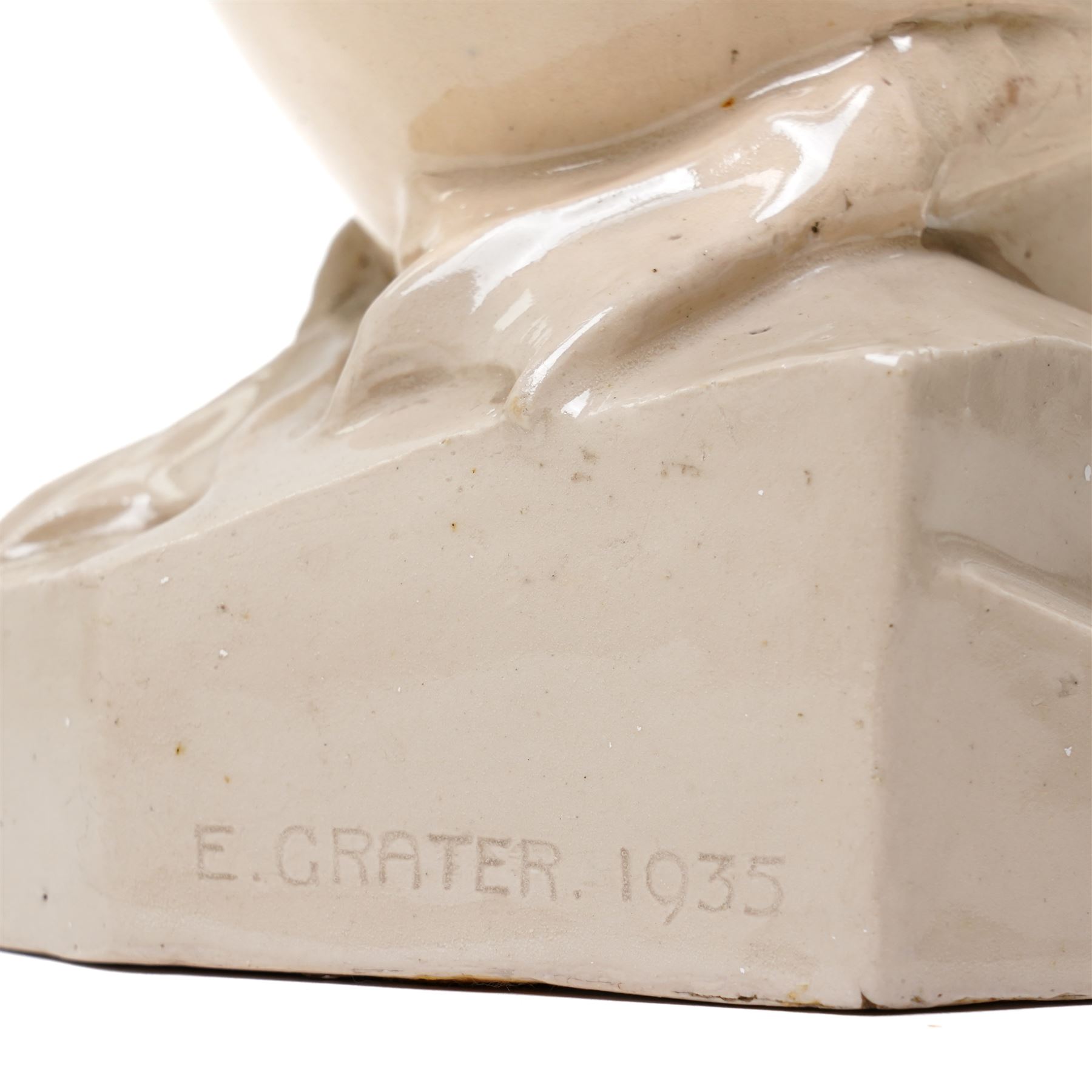 Early 20th century glazed figure of a duck perched upon a rock, signed 'E Grater' and dated 1935, H30cm 